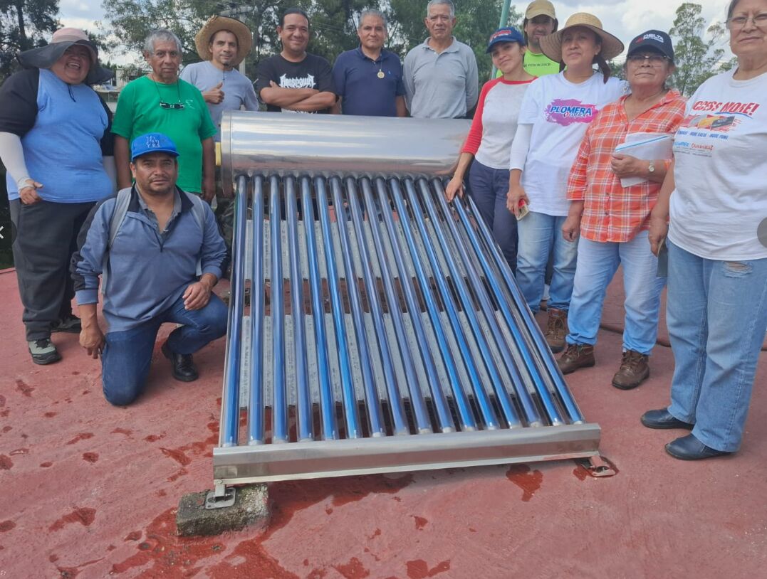 Alumnos con calentador solar instalado en práctica